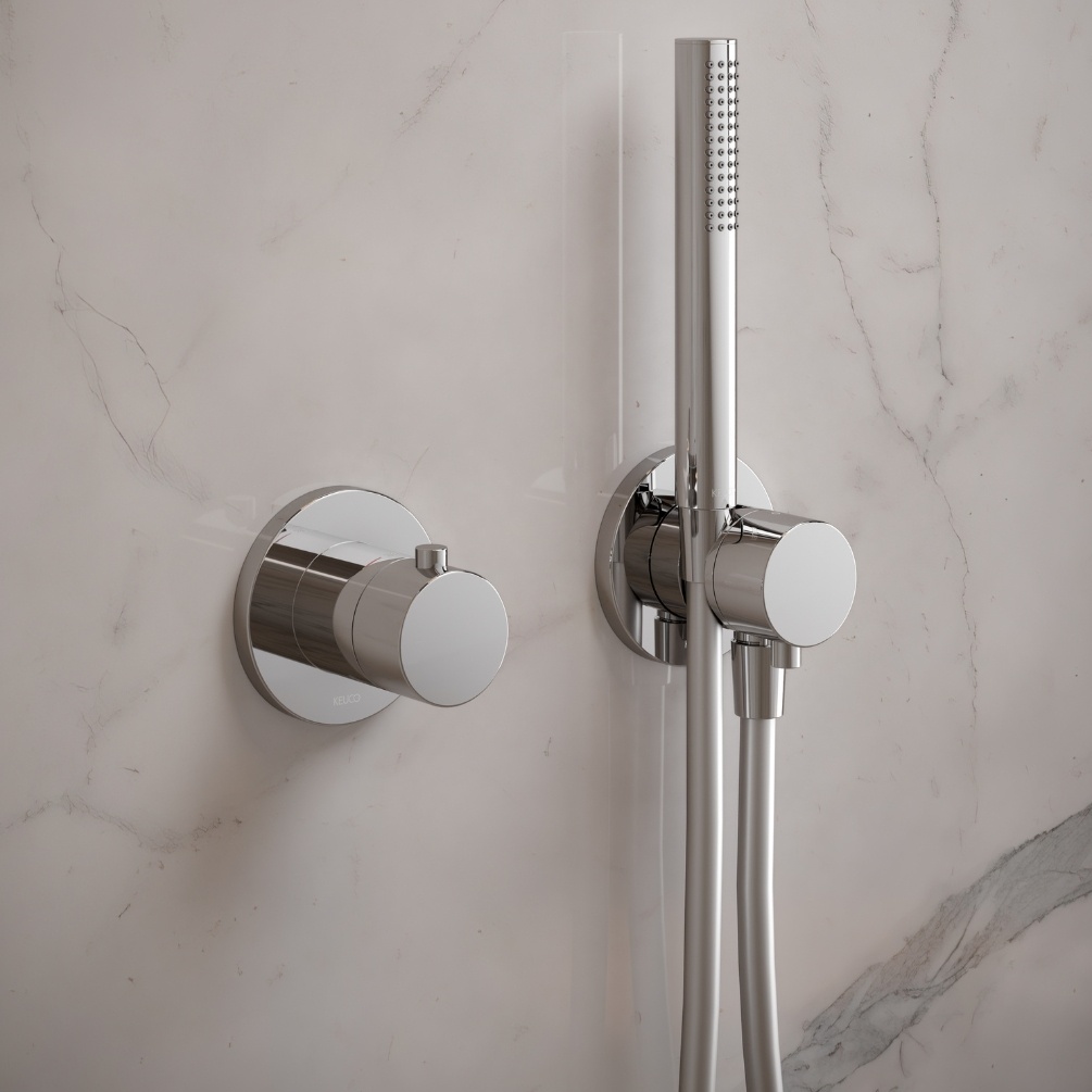 Close up product lifestyle image of the Keuco IXMO Chrome Round Thermostatic Mixer 59553 010001 paired with a handset shower